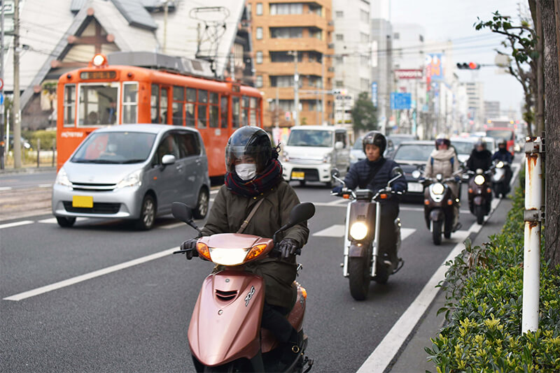 朝早い松山市内・原付が列をなして走る